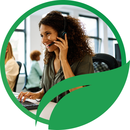 Na imagem, há a fotografia de uma mulher trabalhando como funcionária de uma empresa de telemarketing, atendendo a um cliente no telefone. A imagem está em uma moldura circular na cor verde, que lembra o formato de uma folha. 